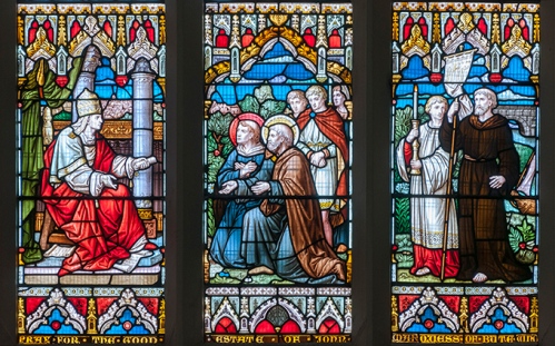 Detail of a stained glass window with a group of figures.