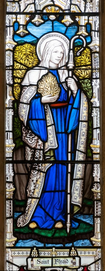 stained glass figure of St Ffraid (Brigid).